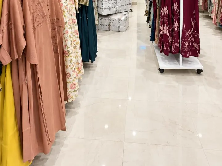 Vismay Hyderabad: glossy marble-finish flooring between garment rails